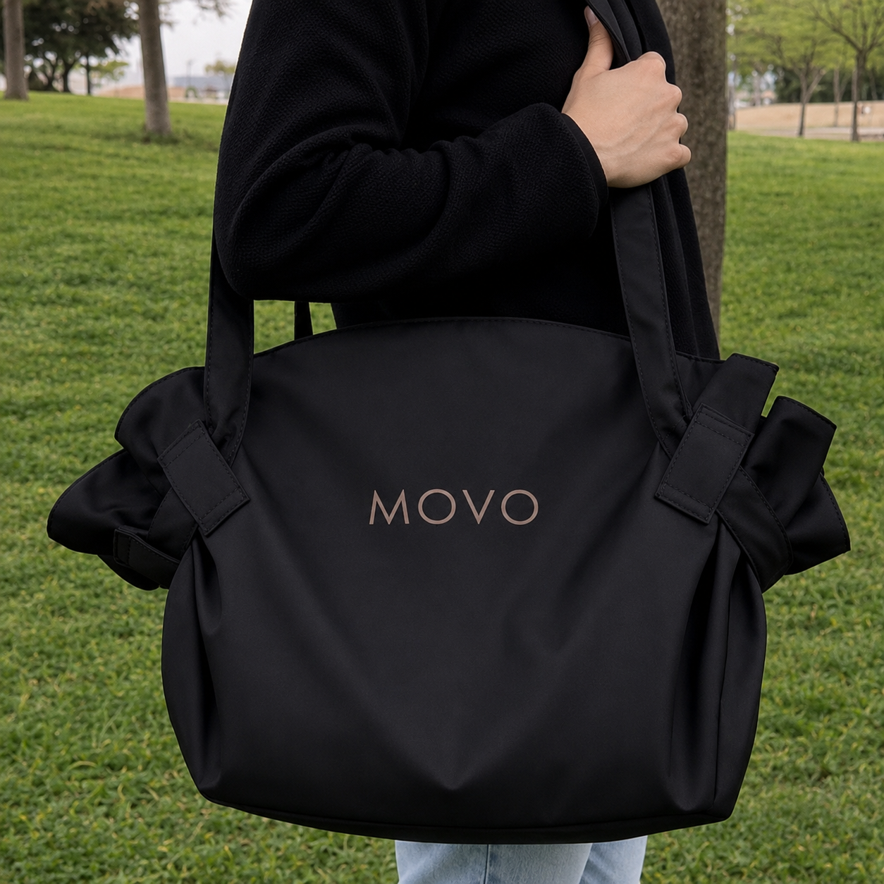 Black Movo Bag carried by hand outdoors